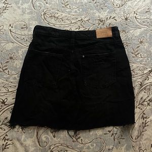 Distressed black denim skirt